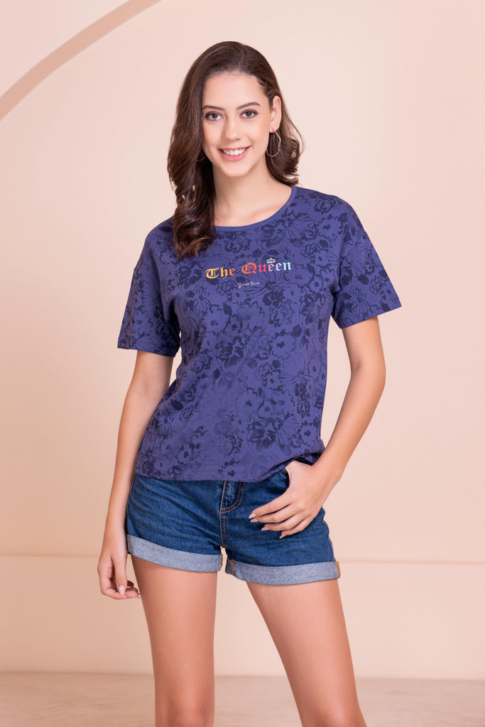 A woman wearing a round neck ,relaxed fit printed cotton top in move Color