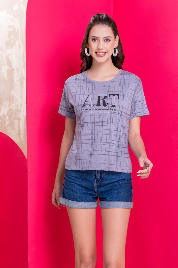 A woman wearing a round neck ,relaxed fit printed cotton top in grey Color