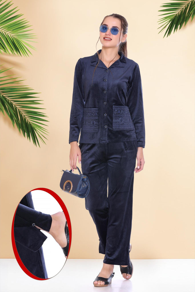 A woman wearing a full sleeve, relaxed fit, velvet night suit with lapel collar in Navy Color 
