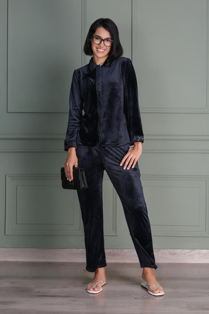 A woman wearing a  full sleeve, relaxed fit, velvet night suit  in Navy Color