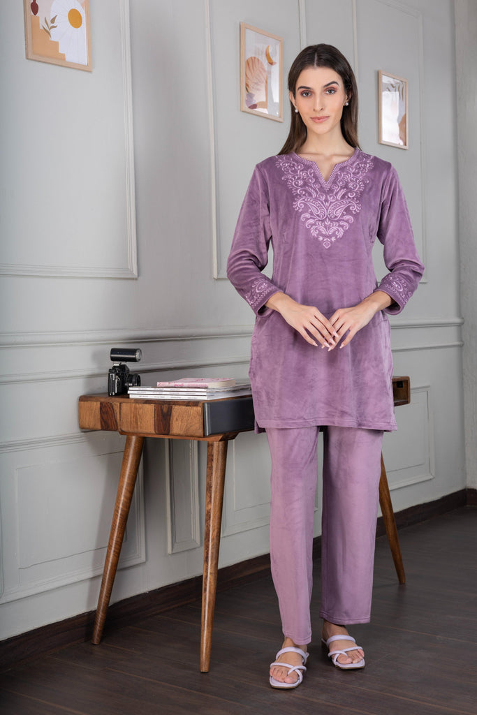 A woman wearing a full sleeve, relaxed fit, Velvet Co-Ord set with V-neck and floral embroidery in Lilac Snow Color