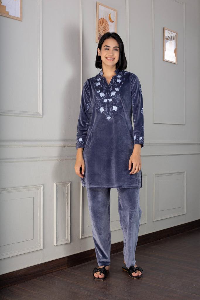 A woman wearing a full sleeve, relaxed fit, velvet night suit with floral embroidery in S.Grey Color