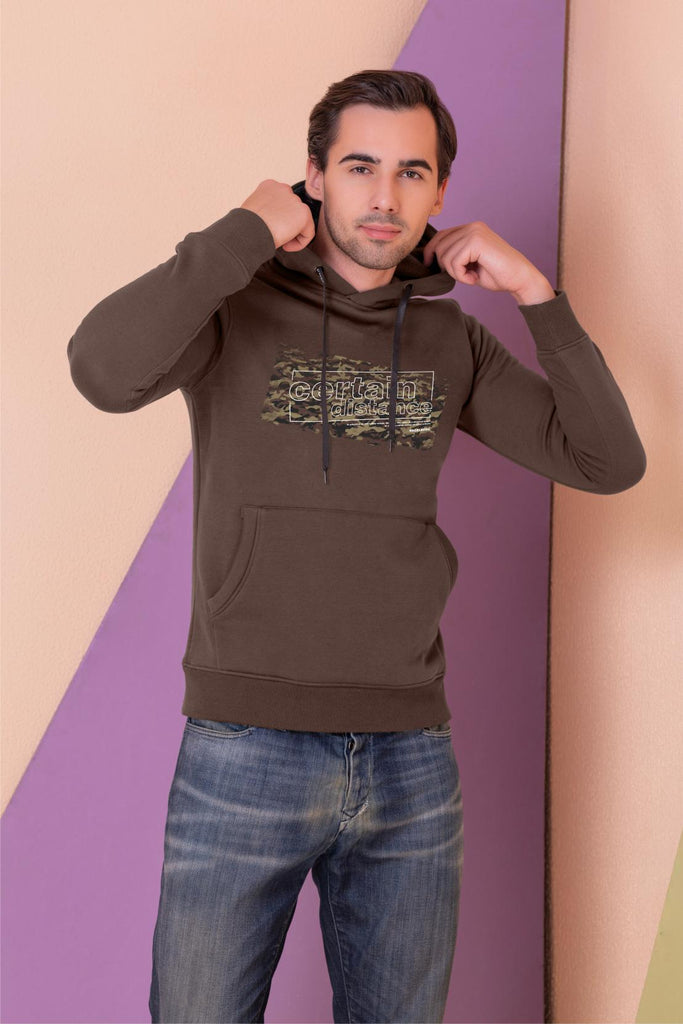  A  man wearing a full sleeve, relaxed fit, fleece printed hoodie with elasticed cuff and hem in bear Color 
