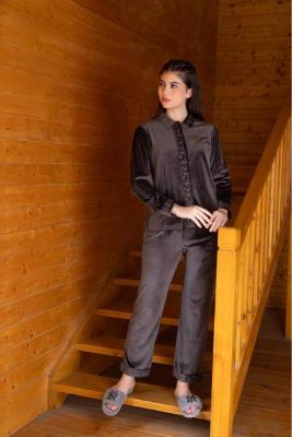 A woman wearing a  full sleeve, relaxed fit, velvet night suit  in  D.Coffee Color